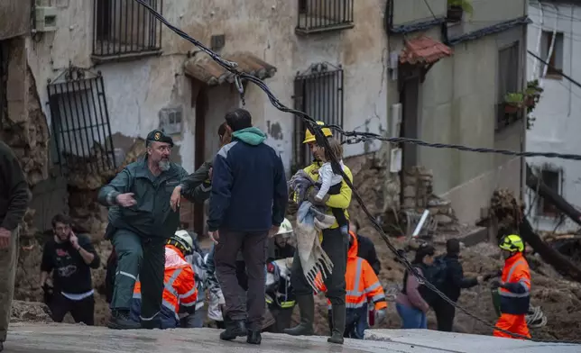 Members of emergency services and Guardia Civil rescue people trapped in their homes after floods in Letur, Albacete, Tuesday, Oct. 29, 2024. (Víctor Fernández/Europa Press via AP)