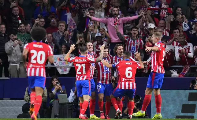 Atletico Madrid's Julian Alvarez celebrates with teammates after scoring his sides first goal during the Champions League opening phase soccer match between Atletico Madrid and Lille at the Metropolitano stadium in Madrid, Spain, Wednesday, Oct. 23, 2024. (AP Photo/Manu Fernandez)