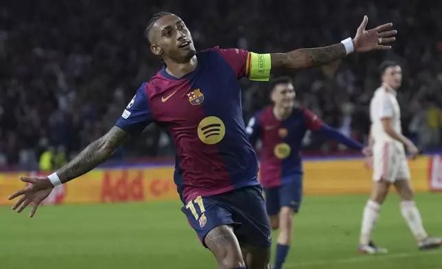 Barcelona's Raphinha celebrates after scoring his side's third goal during the Champions League opening phase soccer match between Barcelona and Bayern Munich at the Lluis Companys Olympic Stadium in Barcelona, Spain, Wednesday, Oct. 23, 2024. (AP Photo/Emilio Morenatti)