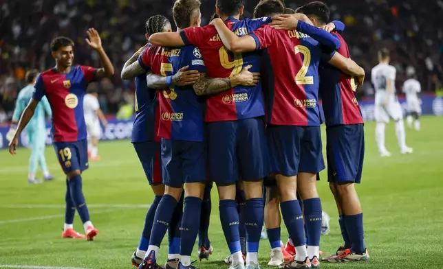 Barcelona's Robert Lewandowski, centre, celebrates after scoring his side's fourth goal during the Champions League soccer match between Barcelona and Young Boys at the Lluis Companys Olympic Stadium in Barcelona, Spain, Tuesday, Oct. 1, 2024. (AP Photo/Joan Monfort)