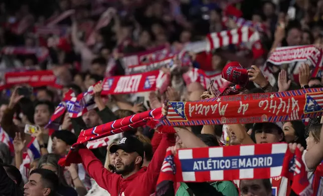 Fans cheer before the start of the Champions League opening phase soccer match between Atletico Madrid and Lille at the Metropolitano stadium in Madrid, Spain, Wednesday, Oct. 23, 2024. (AP Photo/Manu Fernandez)