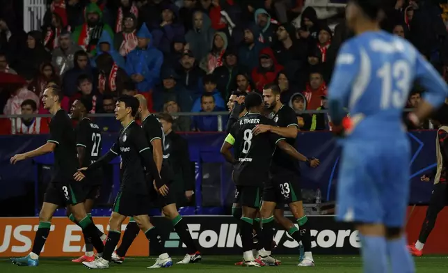 Feyenoord players celebrate after a goal during the Champions League soccer match between Girona and Feyenoord, in Girona, Spain, Wednesday, Oct. 2, 2024. (AP Photo/Joan Monfort)