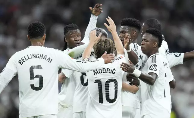 Real Madrid players celebrate after a goal during the La Liga soccer match between Real Madrid and Villareal in Madrid, Spain, on Saturday, Oct. 5, 2024. (AP Photo/Bernat Armangue)