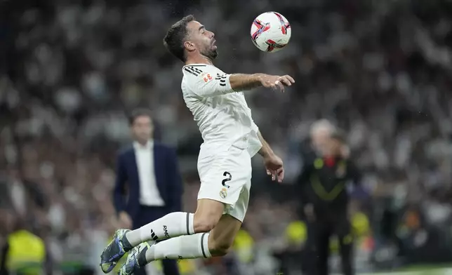 Real Madrid's Dani Carvajal receives the ball during the La Liga soccer match between Real Madrid and Villareal in Madrid, Spain, on Saturday, Oct. 5, 2024. (AP Photo/Bernat Armangue)