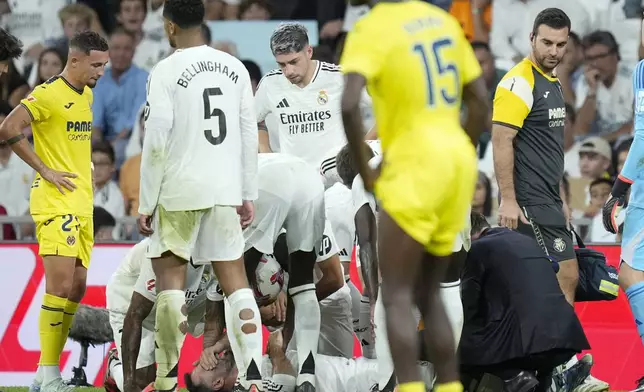 Real Madrid's Dani Carvajal grimaces in pain during the La Liga soccer match between Real Madrid and Villareal in Madrid, Spain, on Saturday, Oct. 5, 2024. (AP Photo/Bernat Armangue)