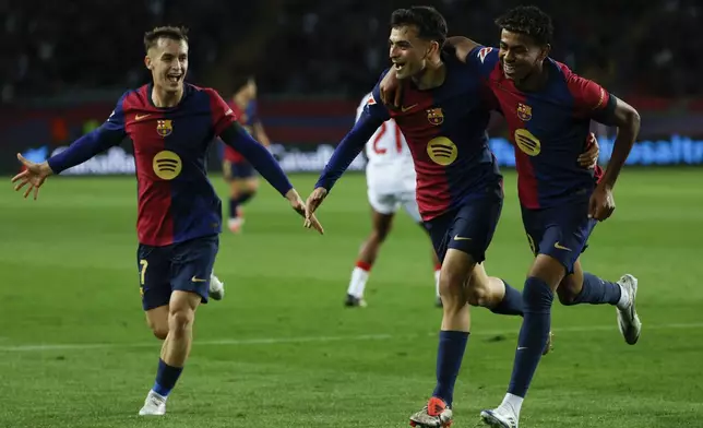 Barcelona's Pedri, center, celebrates with teammates after scoring his side's second goal during a Spanish La Liga soccer match between Barcelona and Sevilla at the Olimpic Lluis Companys stadium in Barcelona, Spain, Sunday, Oct. 20, 2024. (AP Photo/Joan Monfort)