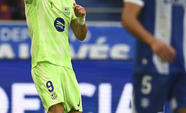 Barcelona's Robert Lewandowski celebrates after scoring his side's 3rd goal against Alavez during a Spanish La Liga soccer match at the Mendizorroza stadium in Vitoria-Gasteiz, Spain, Sunday, Oct. 6, 2024. (AP Photo/Miguel Oses)