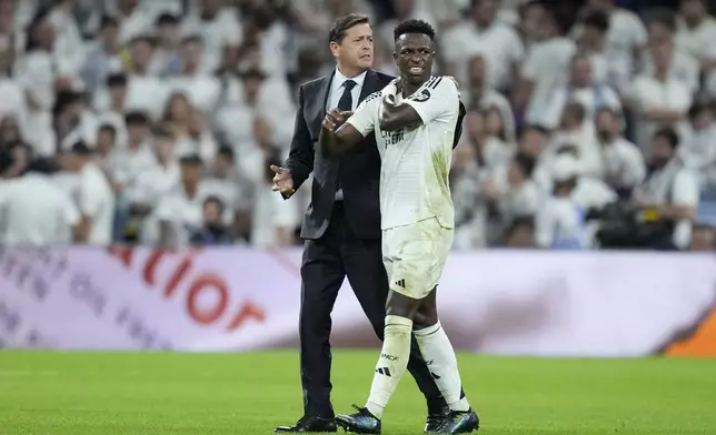 Real Madrid's Vinicius Junior leaves the pitch injured during the La Liga soccer match between Real Madrid and Villareal in Madrid, Spain, on Saturday, Oct. 5, 2024. (AP Photo/Bernat Armangue)