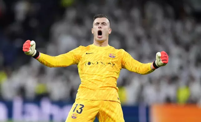 Barcelona's goalkeeper Inaki Pena celebrates at the end of a Spanish La Liga soccer match between Real Madrid and Barcelona at the Santiago Bernabeu stadium in Madrid, Spain, Saturday, Oct. 26, 2024. (AP Photo/Bernat Armangue)