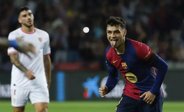 Barcelona's Pedri celebrates after scoring his side's second goal during a Spanish La Liga soccer match between Barcelona and Sevilla at the Olimpic Lluis Companys stadium in Barcelona, Spain, Sunday, Oct. 20, 2024. (AP Photo/Joan Monfort)