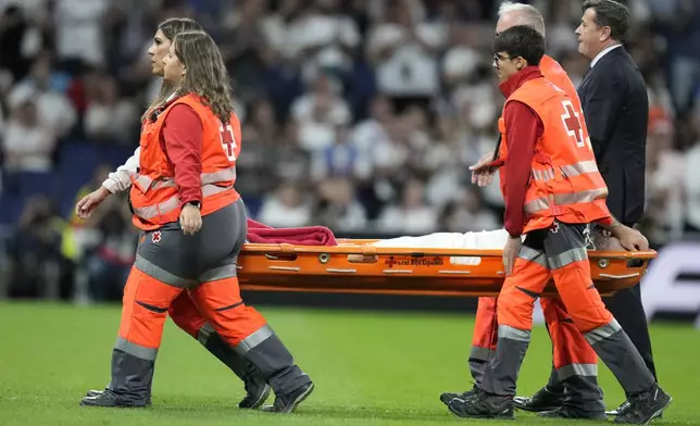 Real Madrid's Dani Carvajal is carried off the pitch during the La Liga soccer match between Real Madrid and Villareal in Madrid, Spain, on Saturday, Oct. 5, 2024. (AP Photo/Bernat Armangue)