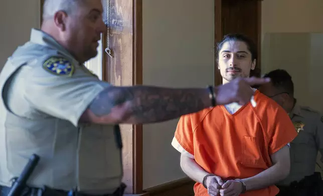 FILE - Ryan Martinez is led into court for a preliminary and detention hearing at the Rio Arriba Courthouse, in Tierra Amarilla, N.M., Friday, Oct. 13, 2023. (Eddie Moore/The Albuquerque Journal via AP, File)