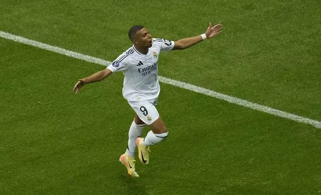 FILE - Real Madrid's Kylian Mbappe celebrates after scoring his side's second goal during the UEFA Super Cup Final soccer match between Real Madrid and Atalanta at the Narodowy stadium in Warsaw, Poland, Aug. 14, 2024. (AP Photo/Darko Vojinovic, file)