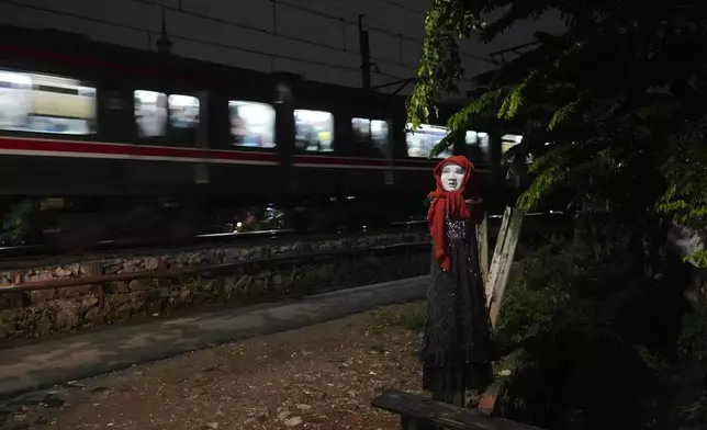 An effigy is seen near a railway track where two commuter trains collided in 1987, killing 139 people, in Bintaro, Indonesia, Friday, Oct. 25, 2024. (AP Photo/Tatan Syuflana)