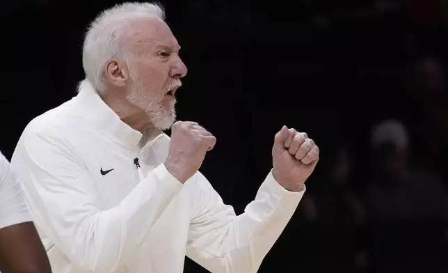 San Antonio Spurs head coach Gregg Popovich calls out to players during the first half of an NBA preseason basketball game against the Miami Heat, Tuesday, Oct. 15, 2024, in Miami. (AP Photo/Wilfredo Lee)
