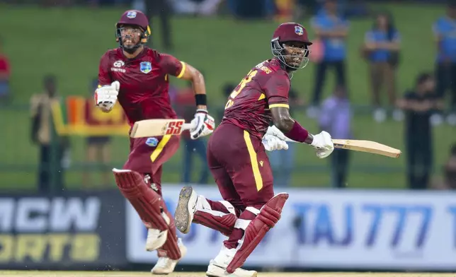 West Indies' Sherfane Rutherford, right, and Roston Chase run between the wickets during the first ODI cricket match between Sri Lanka and West Indies in Pallekele, Sri Lanka, Sunday, Oct. 20, 2024. (AP Photo/Viraj Kothalawala)