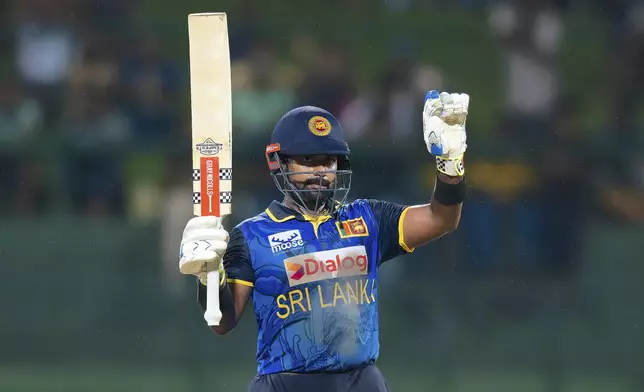 Sri Lanka's Captain Charith Asalanka celebrates his fifty runs during the first ODI cricket match between Sri Lanka and West Indies in Pallekele, Sri Lanka, Sunday, Oct. 20, 2024. (AP Photo/Viraj Kothalawala)