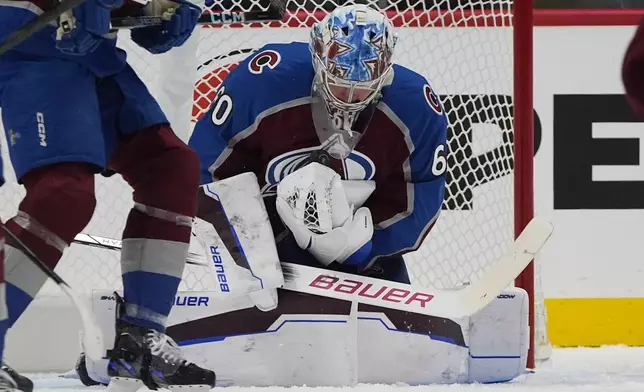 Colorado Avalanche goaltender Justus Annunen makes a save against the Dallas Stars in the first period of an NHL preseason hockey game Monday, Sept. 23, 2024, in Denver. (AP Photo/David Zalubowski)