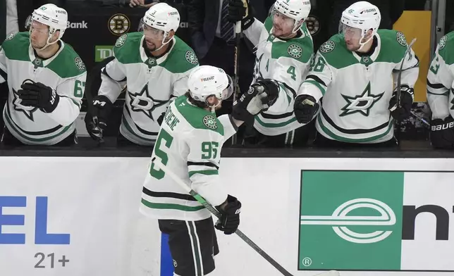 Dallas Stars center Matt Duchene (95) celebrates with teammates after scoring in the first period of an NHL hockey game against the Boston Bruins, Thursday, Oct. 24, 2024, in Boston. (AP Photo/Steven Senne)