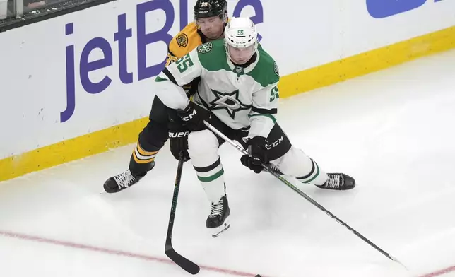 Dallas Stars defenseman Thomas Harley, front right, and Boston Bruins center Morgan Geekie, back left, pursue the puck in the second period of an NHL hockey game, Thursday, Oct. 24, 2024, in Boston. (AP Photo/Steven Senne)