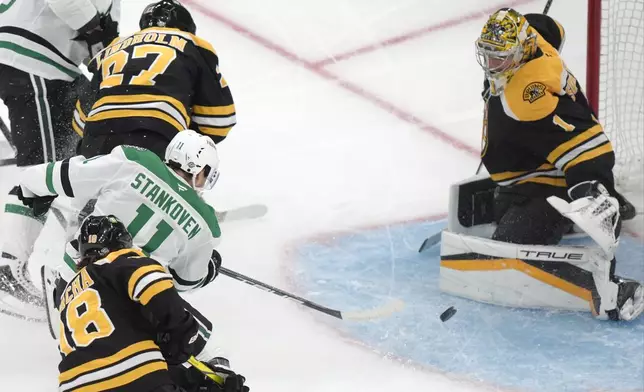 Dallas Stars center Logan Stankoven (11) hits the puck past Boston Bruins goaltender Jeremy Swayman (1) to score in the second period of an NHL hockey game, Thursday, Oct. 24, 2024, in Boston. (AP Photo/Steven Senne)