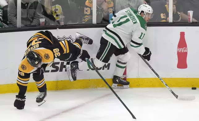 Boston Bruins center Morgan Geekie (39) and Dallas Stars center Logan Stankoven (11) pursue the puck in the second period of an NHL hockey game, Thursday, Oct. 24, 2024, in Boston. (AP Photo/Steven Senne)