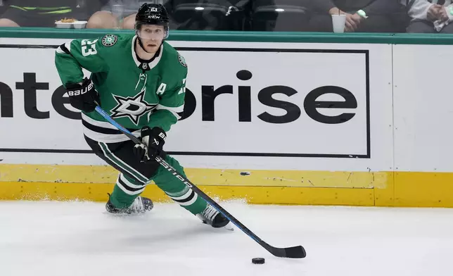 FILE - Dallas Stars defenseman Esa Lindell skates with the puck against the Vegas Golden Knights during the third period in Game 7 of an NHL hockey Stanley Cup first-round playoff series, May 5, 2024, in Dallas. (AP Photo/Brandon Wade, File)