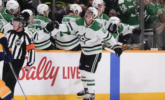 Dallas Stars left wing Mason Marchment (27) celebrates his goal with teammates during the second period of an NHL hockey game against the Nashville Predators, Thursday, Oct. 10, 2024, in Nashville, Tenn. (AP Photo/George Walker IV)