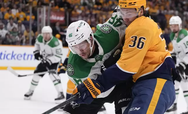 Dallas Stars defenseman Ilya Lyubushkin (46) and Nashville Predators left wing Cole Smith (36) collide as they chase the puck during the second period of an NHL hockey game Thursday, Oct. 10, 2024, in Nashville, Tenn. (AP Photo/George Walker IV)