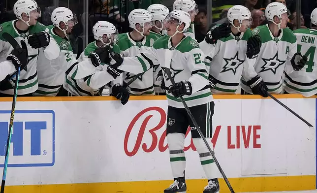 Dallas Stars left wing Mason Marchment (27) celebrates his goal with teammates during the second period of an NHL hockey game Nashville Predators, Thursday, Oct. 10, 2024, in Nashville, Tenn. (AP Photo/George Walker IV)