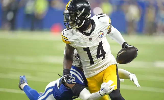 Pittsburgh Steelers wide receiver George Pickens (14) is tackled by Indianapolis Colts safety Julian Blackmon (32) after making a catch during the second half of an NFL football game Sunday, Sept. 29, 2024, in Indianapolis. (AP Photo/Michael Conroy)