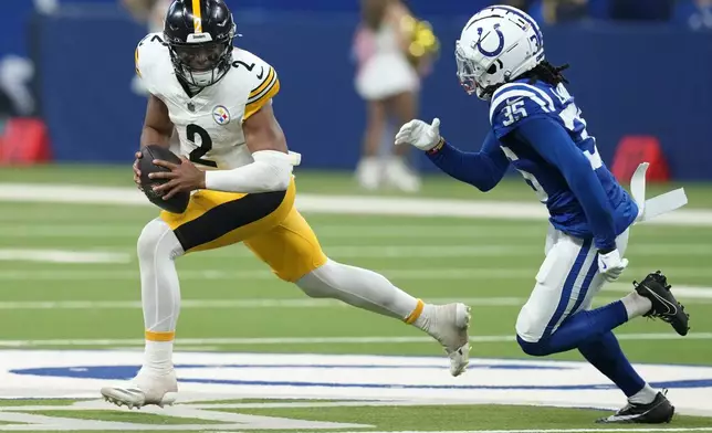 Pittsburgh Steelers quarterback Justin Fields (2) is chased out of the pocket by Indianapolis Colts cornerback Chris Lammons (35) during the second half of an NFL football game Sunday, Sept. 29, 2024, in Indianapolis. (AP Photo/Darron Cummings)