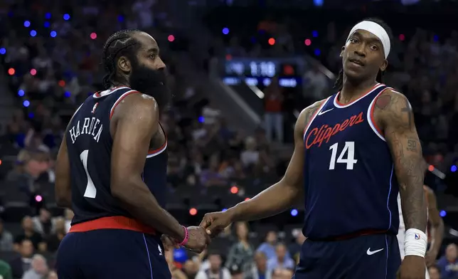 LA Clippers guard James Harden, left, celebrates his and-one foul with guard Terrance Mann during the first half of an NBA basketball game against the Phoenix Suns, Wednesday, Oct. 23, 2024, in Inglewood, Calif. (AP Photo/Ryan Sun)