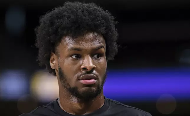 Los Angeles Lakers guard Bronny James (9) looks on before a preseason NBA basketball game against the Phoenix Suns, Sunday, Oct. 6, 2024, in Palm Desert, Calif. (AP Photo/William Liang)