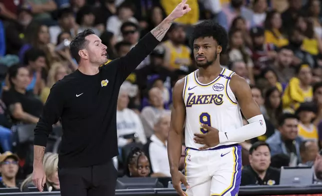 Los Angeles Lakers head coach JJ Redick, left, yells orders to the team while guard Bronny James (9) goes onto the court during the second half of a preseason NBA basketball game Sunday, Oct. 6, 2024, in Palm Desert, Calif. (AP Photo/William Liang)