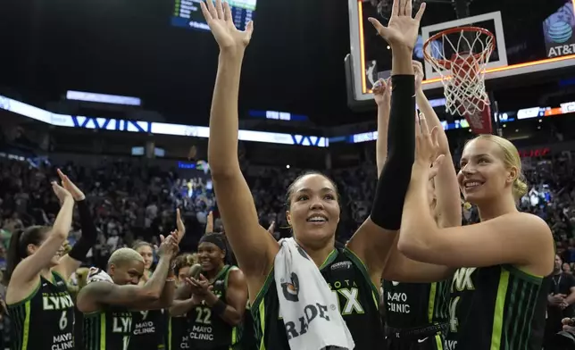 Minnesota Lynx forward Napheesa Collier, center, celebrates with teammates after the 88-77 win against the Connecticut Sun of Game 5 of a WNBA basketball semifinals, Tuesday, Oct. 8, 2024, in Minneapolis. (AP Photo/Abbie Parr)