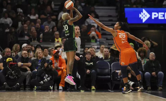 Guard Courtney Williams (10) of the Minnesota Lynx shoots the ball as forward Alyssa Thomas (25) of the Connecticut Sun defends during the first half of Game 2 of a WNBA basketball semifinals game, at Target Center, Tuesday, October 1, 2024, in Minneapolis, Minn. (AP Photo/Adam Bettcher)