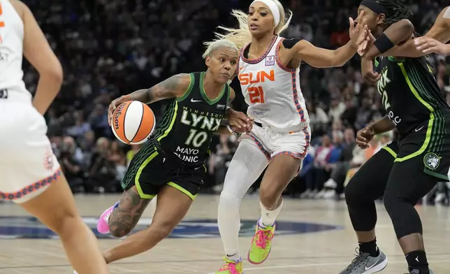 Minnesota Lynx guard Courtney Williams (10) works toward the basket as Connecticut Sun guard DiJonai Carrington (21) defends during the second half of Game 5 of a WNBA basketball semifinals, Tuesday, Oct. 8, 2024, in Minneapolis. (AP Photo/Abbie Parr)