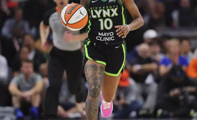 Minnesota Lynx guard Courtney Williams (10) brings the ball up the court during the second half of Game 2 of a WNBA basketball semifinals game against the Connecticut Sun, Tuesday, Oct. 1, 2024, in Minneapolis. (AP Photo/Adam Bettcher)