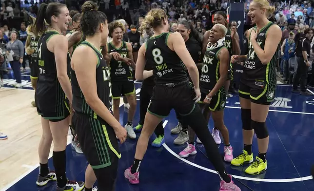 Minnesota Lynx players celebrates after the 88-77 win against the Connecticut Sun of Game 5 of a WNBA basketball semifinals, Tuesday, Oct. 8, 2024, in Minneapolis. (AP Photo/Abbie Parr)