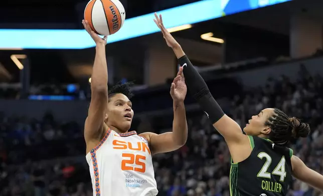 Connecticut Sun forward Alyssa Thomas (25) shoots over Minnesota Lynx forward Napheesa Collier (24) during the first half of Game 5 of a WNBA basketball semifinals, Tuesday, Oct. 8, 2024, in Minneapolis. (AP Photo/Abbie Parr)