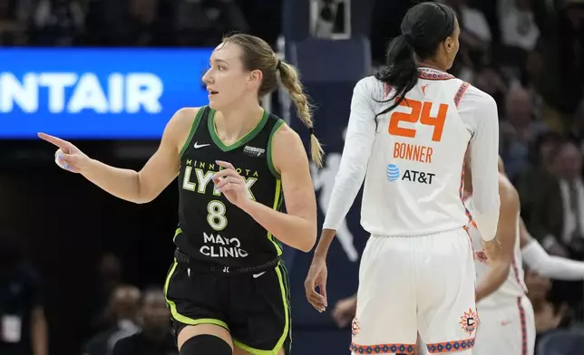 Minnesota Lynx forward Alanna Smith (8) points after making a shot during the first half of Game 5 of a WNBA basketball semifinals game against the Connecticut Sun, Tuesday, Oct. 8, 2024, in Minneapolis. (AP Photo/Abbie Parr)