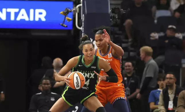 Forward Napheesa Collier (24) of the Minnesota Lynx battles with forward Alyssa Thomas (25) of the Connecticut Sun during the first half of Game 2 of a WNBA basketball semifinals game, at Target Center, Tuesday, October 1, 2024, in Minneapolis, Minn. (AP Photo/Adam Bettcher)