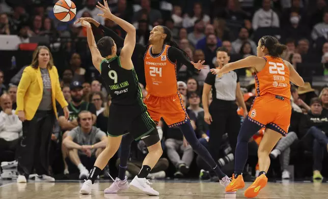 Forward DeWanna Bonner (24) of the Connecticut Sun nocks the ball from forward Cecilia Zandalasini (9) of the Minnesota Lynx during the first half of Game 2 of a WNBA basketball semifinals game, at Target Center, Tuesday, October 1, 2024, in Minneapolis, Minn. (AP Photo/Adam Bettcher)