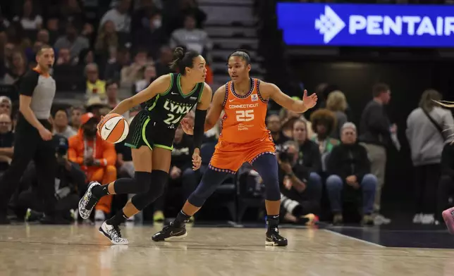 Forward Napheesa Collier (24) of the Minnesota Lynx drives as forward Alyssa Thomas (25) of the Connecticut Sun defends, during the first half of Game 2 of a WNBA basketball semifinals game, at Target Center, Tuesday, October 1, 2024, in Minneapolis, Minn. (AP Photo/Adam Bettcher)