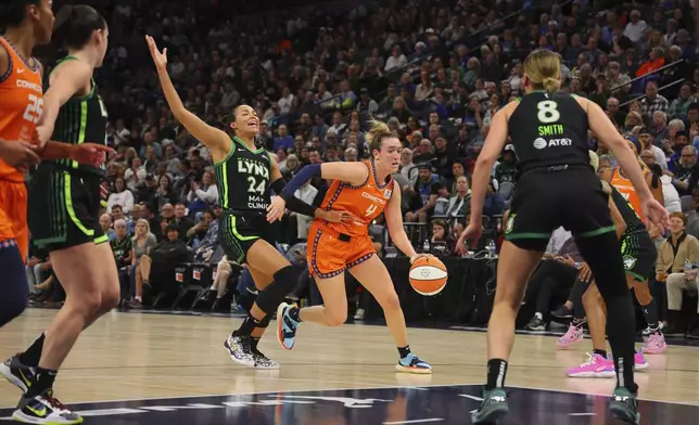 Guard Marina Mabrey (4) of the Connecticut Sun drives with the ball as forward Napheesa Collier (24) of the Minnesota Lynx defends during the first half of Game 2 of a WNBA basketball semifinals game, at Target Center, Tuesday, October 1, 2024, in Minneapolis, Minn. (AP Photo/Adam Bettcher)