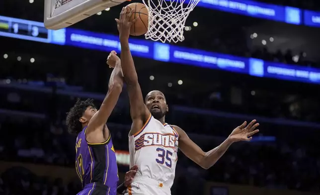 Phoenix Suns forward Kevin Durant (35) goes to the basket against Los Angeles Lakers guard Max Christie (12) during the first half of an NBA basketball game against the in Los Angeles, Friday, Oct. 25, 2024. (AP Photo/Eric Thayer)