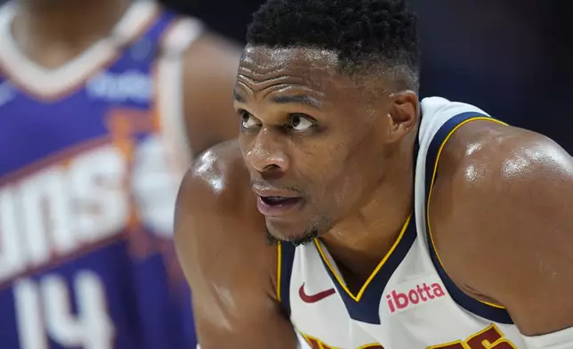 Denver Nuggets guard Russell Westbrook waits for play to resume in the second half of an NBA preseason game against the Phoenix Suns, Sunday, Oct. 13, 2024, in Denver. (AP Photo/David Zalubowski)