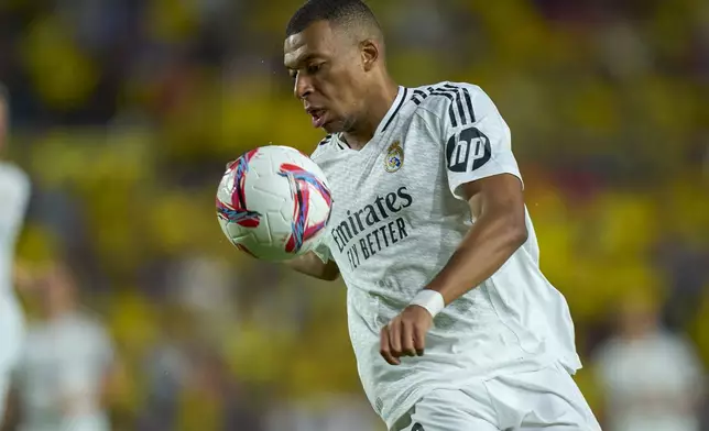 FILE - Real Madrid's Kylian Mbappe tries to control the ball during the Spanish La Liga soccer match between Las Palmas and Real Madrid at the Gran Canaria stadium in Las Palmas, Spain's Canary Islands, Thursday, Aug. 29, 2024. (AP Photo/Gabriel Jimenez, File)