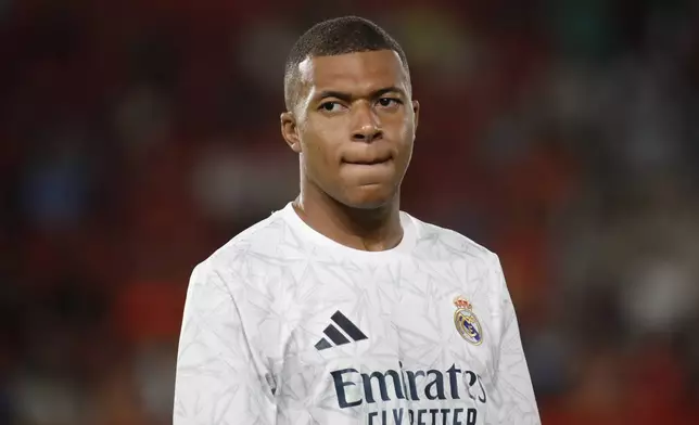 FILE - Real Madrid's Kylian Mbappe looks on before the start of a Spanish La Liga soccer match between Mallorca and Real Madrid at the Son Moix Stadium in Palma de Mallorca, Spain, Sunday, Aug. 18, 2024. (AP Photo/Francisco Ubilla, File)